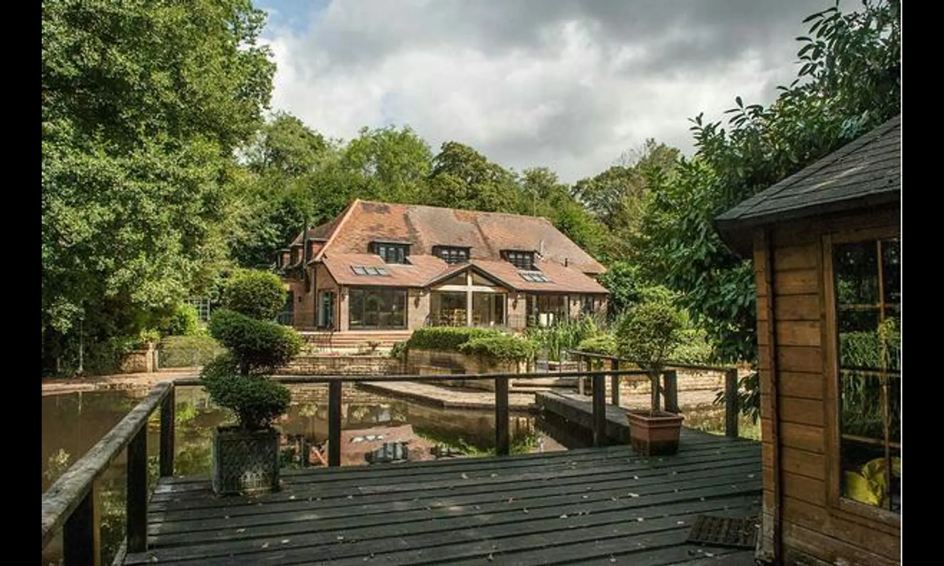 The house at Netley Mill House seen across the mill pond from the deck